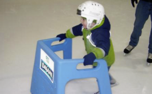 Young child using Skate Helper skating aid