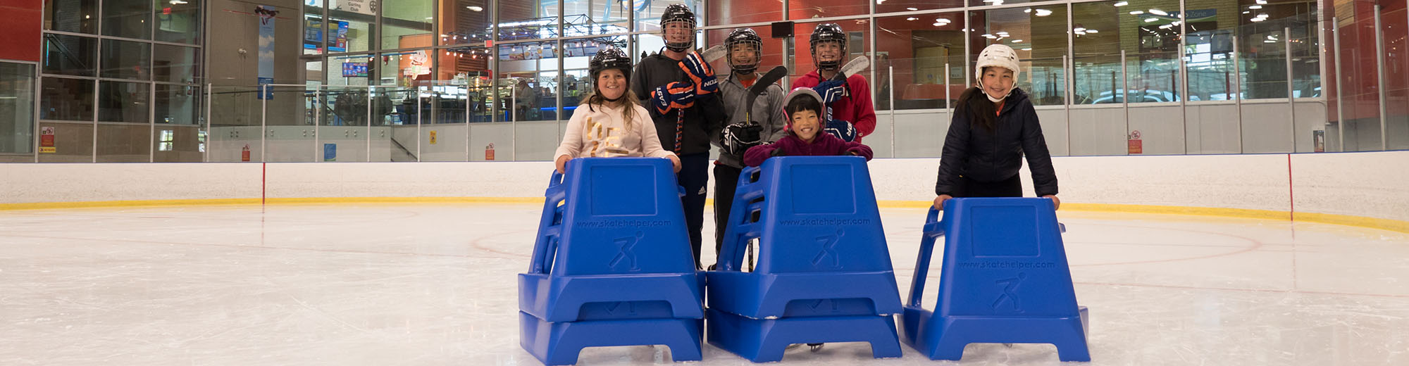 Group of kids with Skate Helper skating aid